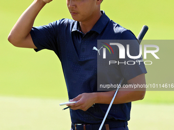 Justin Suh of San Jose, California acknowledges the fans as he walks off the 18th green after completing the  second round during  The Memor...