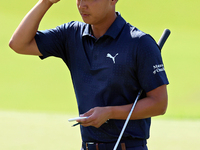 Justin Suh of San Jose, California acknowledges the fans as he walks off the 18th green after completing the  second round during  The Memor...