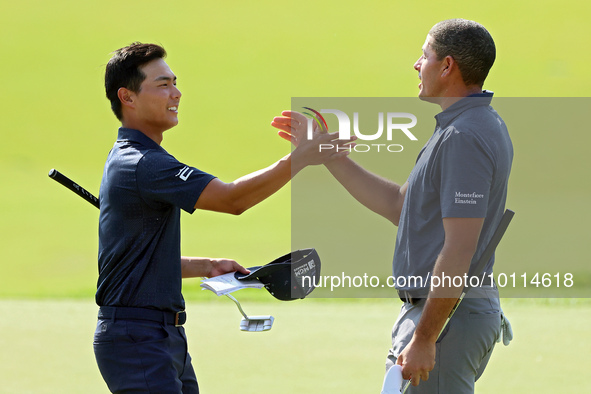 Justin Suh of San Jose, California greets Joseph Bramlett of Las Vegas, Nevada on the 18th green after completing the second round during  T...