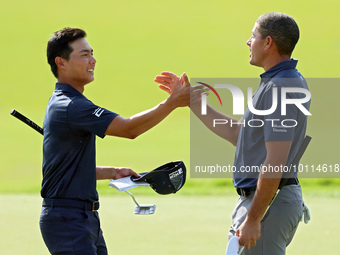 Justin Suh of San Jose, California greets Joseph Bramlett of Las Vegas, Nevada on the 18th green after completing the second round during  T...