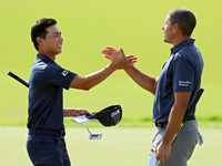 Justin Suh of San Jose, California greets Joseph Bramlett of Las Vegas, Nevada on the 18th green after completing the second round during  T...