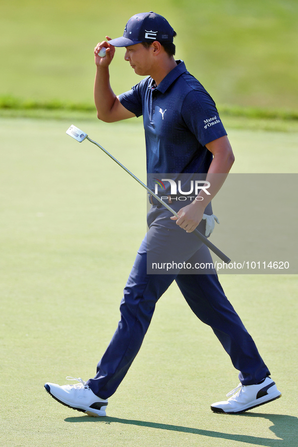 Justin Suh of San Jose, California acknowledges the fans as he walks on the 18th green after putting during  The Memorial Tournament present...