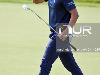 Justin Suh of San Jose, California acknowledges the fans as he walks on the 18th green after putting during  The Memorial Tournament present...