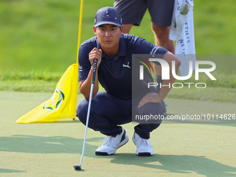 Justin Suh of San Jose, California lines up his putt on the 18th green during the second round during  The Memorial Tournament presented by...