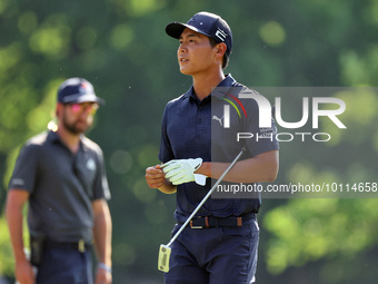 Justin Suh of San Jose, California removes his glove as he walks to the 18th green after hitting from the fairway the  second round during...