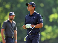 Justin Suh of San Jose, California removes his glove as he walks to the 18th green after hitting from the fairway the  second round during...