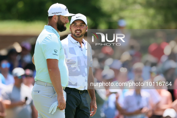 John Rahm of Barrika, Spain waits on the 7th green with Jason Day of Brisbane, Australia during The Memorial Tournament presented by Workday...