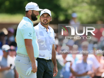 John Rahm of Barrika, Spain waits on the 7th green with Jason Day of Brisbane, Australia during The Memorial Tournament presented by Workday...