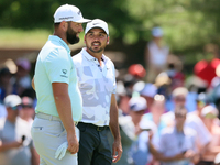 John Rahm of Barrika, Spain waits on the 7th green with Jason Day of Brisbane, Australia during The Memorial Tournament presented by Workday...