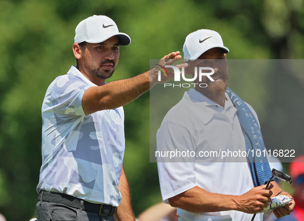 Jason Day of Brisbane, Australia looks over the 8th green with his caddy during The Memorial Tournament presented by Workday at Muirfield Vi...