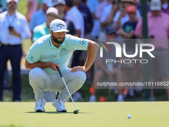 John Rahm of Barrika, Spain lines up his putt on the 7th green with Jason Day of Brisbane, Australia during The Memorial Tournament presente...