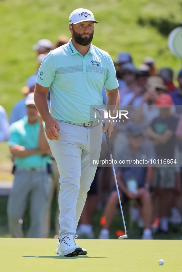 John Rahm of Barrika, Spain walks on the 7th green with Jason Day of Brisbane, Australia during The Memorial Tournament presented by Workday...