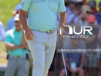 John Rahm of Barrika, Spain walks on the 7th green with Jason Day of Brisbane, Australia during The Memorial Tournament presented by Workday...