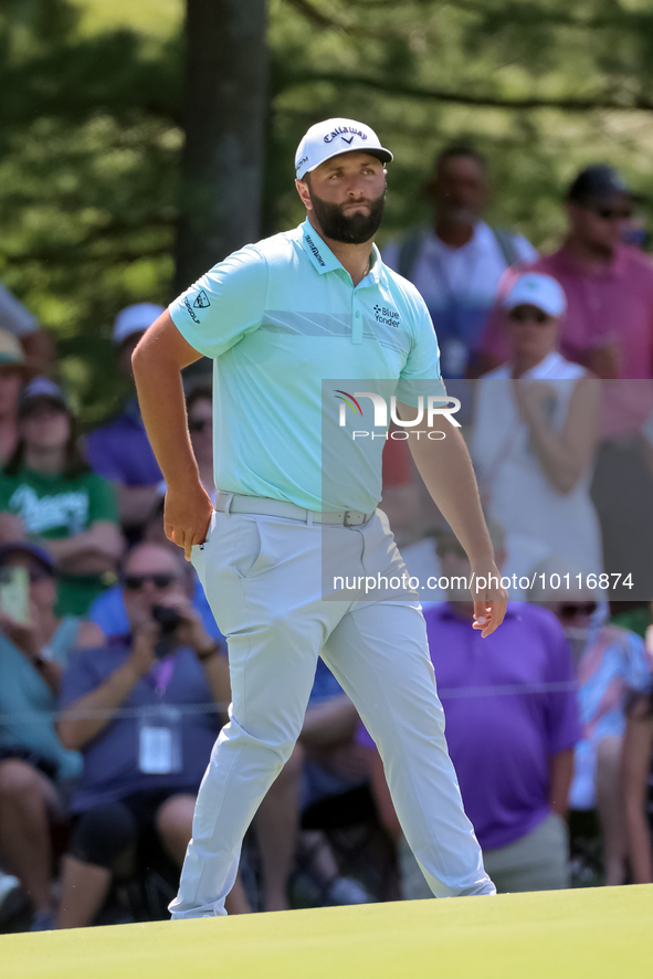 John Rahm of Barrika, Spain walks on the 7th green with Jason Day of Brisbane, Australia during The Memorial Tournament presented by Workday...