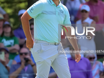 John Rahm of Barrika, Spain walks on the 7th green with Jason Day of Brisbane, Australia during The Memorial Tournament presented by Workday...