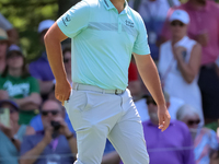 John Rahm of Barrika, Spain walks on the 7th green with Jason Day of Brisbane, Australia during The Memorial Tournament presented by Workday...