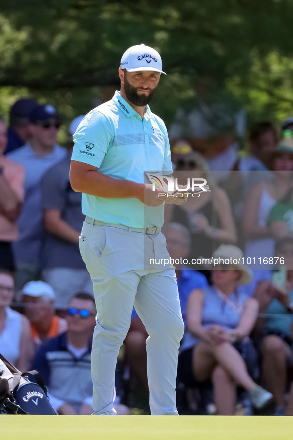 John Rahm of Barrika, Spain waits on the 7th green with Jason Day of Brisbane, Australia during The Memorial Tournament presented by Workday...