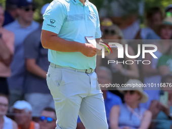 John Rahm of Barrika, Spain waits on the 7th green with Jason Day of Brisbane, Australia during The Memorial Tournament presented by Workday...