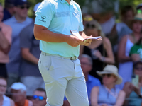 John Rahm of Barrika, Spain waits on the 7th green with Jason Day of Brisbane, Australia during The Memorial Tournament presented by Workday...