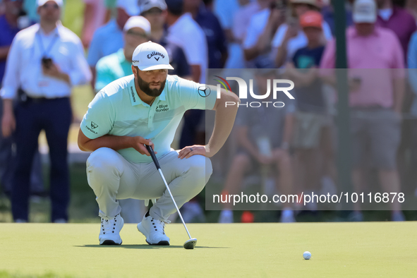 John Rahm of Barrika, Spain lines up his putt on the 7th green with Jason Day of Brisbane, Australia during The Memorial Tournament presente...