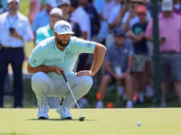 John Rahm of Barrika, Spain lines up his putt on the 7th green with Jason Day of Brisbane, Australia during The Memorial Tournament presente...