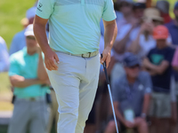 John Rahm of Barrika, Spain walks on the 7th green with Jason Day of Brisbane, Australia during The Memorial Tournament presented by Workday...