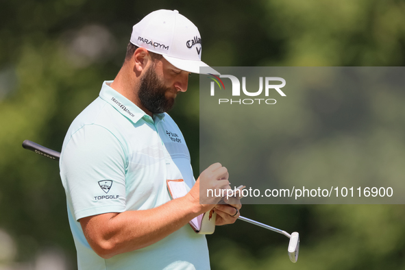 John Rahm of Barrika, Spain writes in his yardage book on the 8th green during The Memorial Tournament presented by Workday at Muirfield Vil...