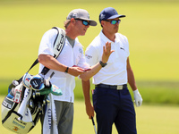 Rickie Fowler of Murrieta California looks down the 5th fairway with his caddie during The Memorial Tournament presented by Workday at Muirf...