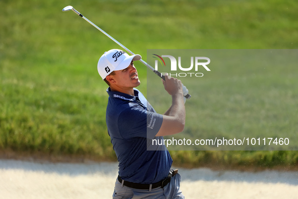 Joseph Bramlett of Las Vegas, Nevada hits from the bunker to the 18th green after completing the second round during  The Memorial Tournamen...