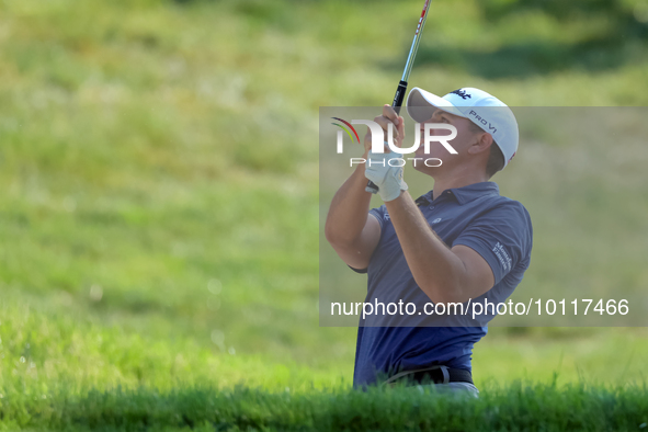 Joseph Bramlett of Las Vegas, Nevada hits from the bunker on the 18th fairway after completing the second round during  The Memorial Tournam...