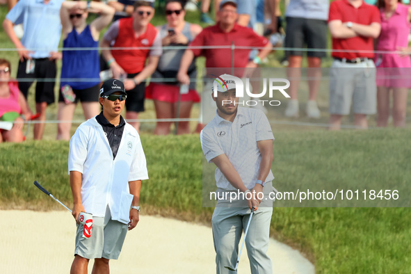 Hideki Matsuyama of Sendai, Japan watches his chip shot from the fringe onto the 18th green during The Memorial Tournament presented by Work...