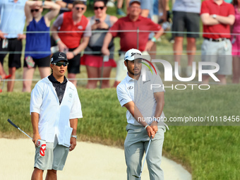 Hideki Matsuyama of Sendai, Japan watches his chip shot from the fringe onto the 18th green during The Memorial Tournament presented by Work...