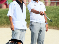 Hideki Matsuyama of Sendai, Japan looks over the 18th green with his caddie during The Memorial Tournament presented by Workday at Muirfield...