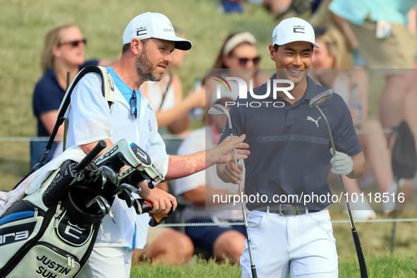 Justin Suh of San Jose, California reacts after making his shot on the 18th green during The Memorial Tournament presented by Workday at Mui...