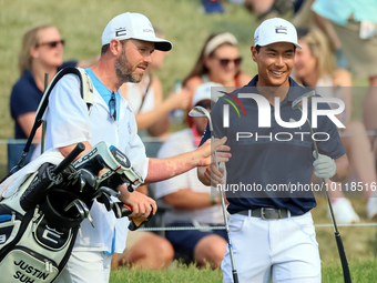 Justin Suh of San Jose, California reacts after making his shot on the 18th green during The Memorial Tournament presented by Workday at Mui...