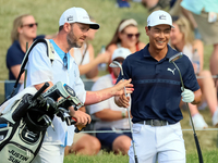 Justin Suh of San Jose, California reacts after making his shot on the 18th green during The Memorial Tournament presented by Workday at Mui...