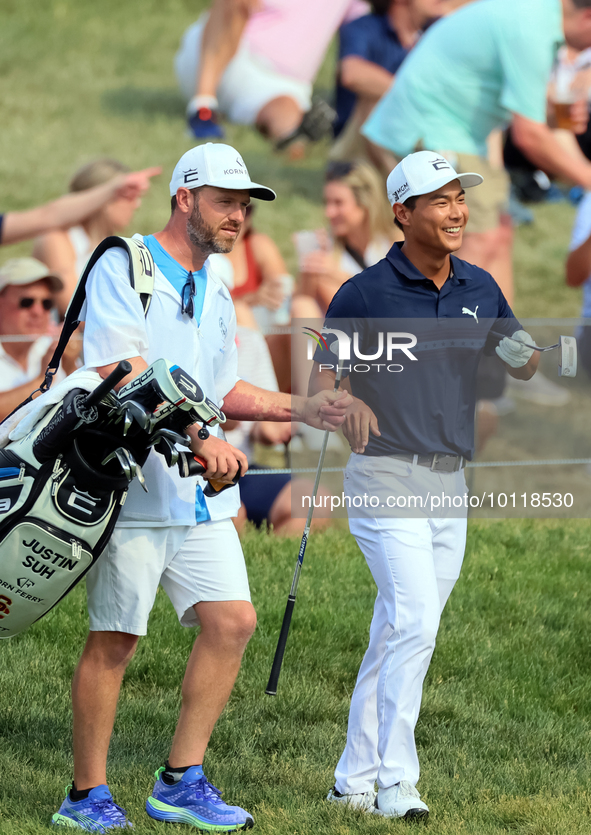 Justin Suh of San Jose, California reacts after making his shot on the 18th green during The Memorial Tournament presented by Workday at Mui...