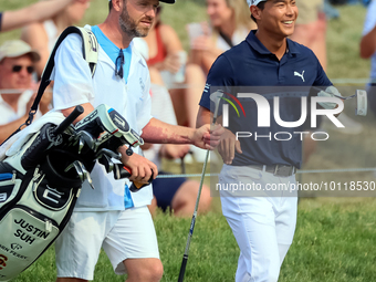 Justin Suh of San Jose, California reacts after making his shot on the 18th green during The Memorial Tournament presented by Workday at Mui...