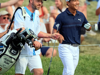 Justin Suh of San Jose, California reacts after making his shot on the 18th green during The Memorial Tournament presented by Workday at Mui...