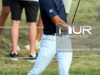 Justin Suh of San Jose, California reacts after making his shot on the 18th green during The Memorial Tournament presented by Workday at Mui...