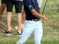 Justin Suh of San Jose, California reacts after making his shot on the 18th green during The Memorial Tournament presented by Workday at Mui...