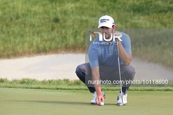 Patrick Cantlay of Jupiter, Florida places his ball on the 18th green during The Memorial Tournament presented by Workday at Muirfield Villa...