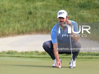 Patrick Cantlay of Jupiter, Florida places his ball on the 18th green during The Memorial Tournament presented by Workday at Muirfield Villa...