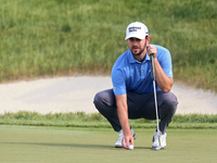 Patrick Cantlay of Jupiter, Florida places his ball on the 18th green during The Memorial Tournament presented by Workday at Muirfield Villa...