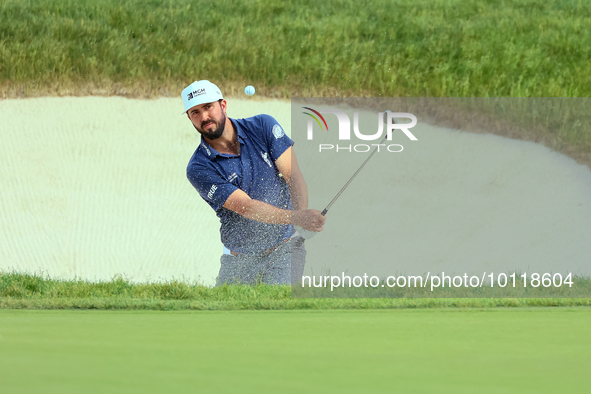 Mark Hubbard of Denver, Colorado hits out of the bumper to the 18th green during The Memorial Tournament presented by Workday at Muirfield V...