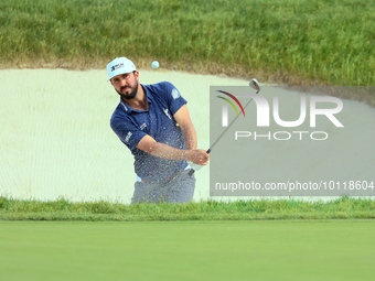 Mark Hubbard of Denver, Colorado hits out of the bumper to the 18th green during The Memorial Tournament presented by Workday at Muirfield V...