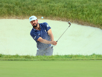 Mark Hubbard of Denver, Colorado hits out of the bumper to the 18th green during The Memorial Tournament presented by Workday at Muirfield V...