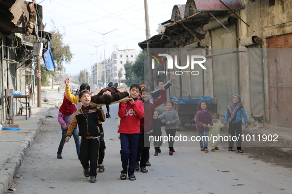 Children playing game martyr in Aleppo January 21, 1, 2016. Live their day to the sound of bullets, playing but they do not go to school bec...