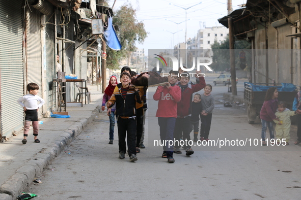 Children playing game martyr in Aleppo January 21, 1, 2016. Live their day to the sound of bullets, playing but they do not go to school bec...