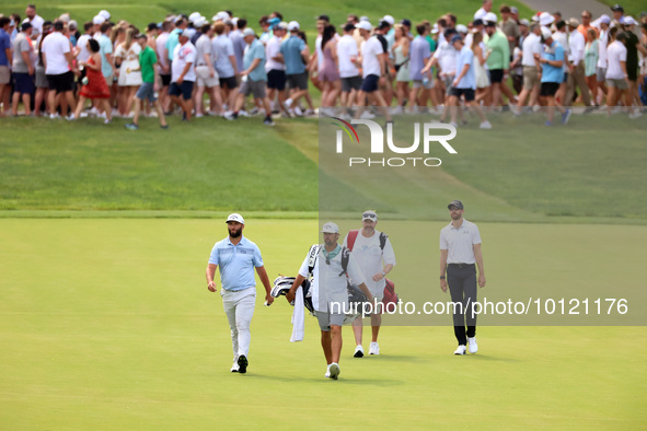 Jon Rahm of Barrika, Spain and Patrick Rodgers of Jupiter, Florida walk on the 18th fairway during The Memorial Tournament presented by Work...